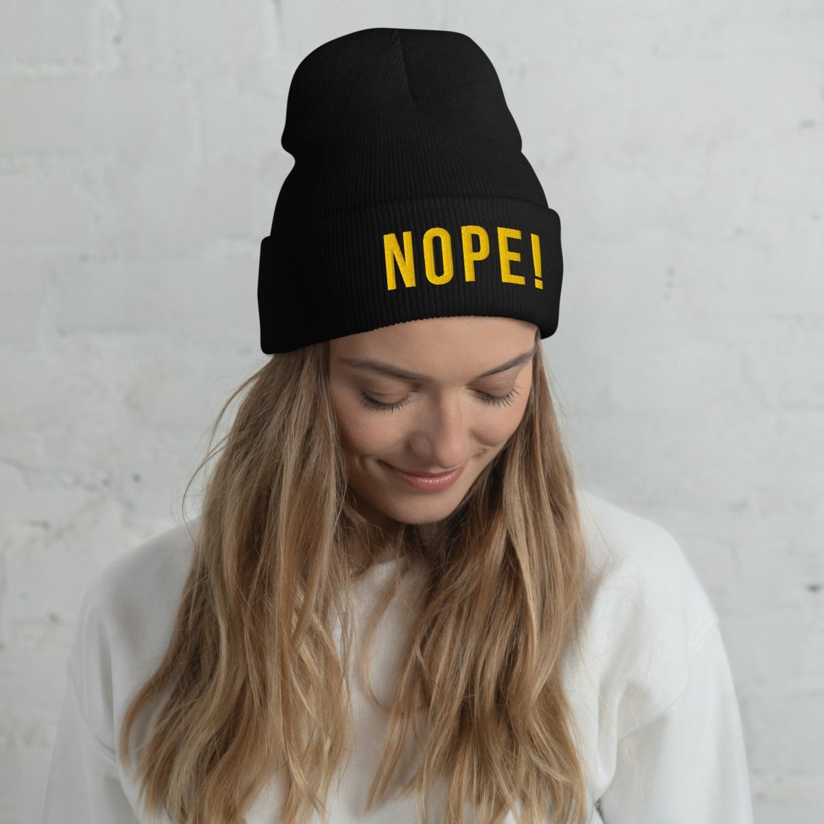 Woman wearing NOPE! Culture black knitted embroided NOPE! Beanie