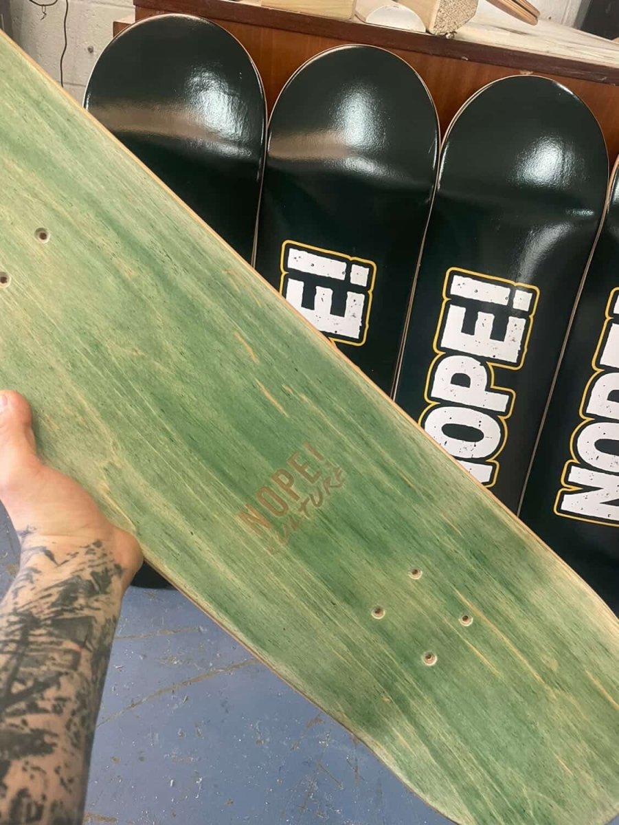 Top view of NOPE! skateboard with NOPE! Culture logo showing