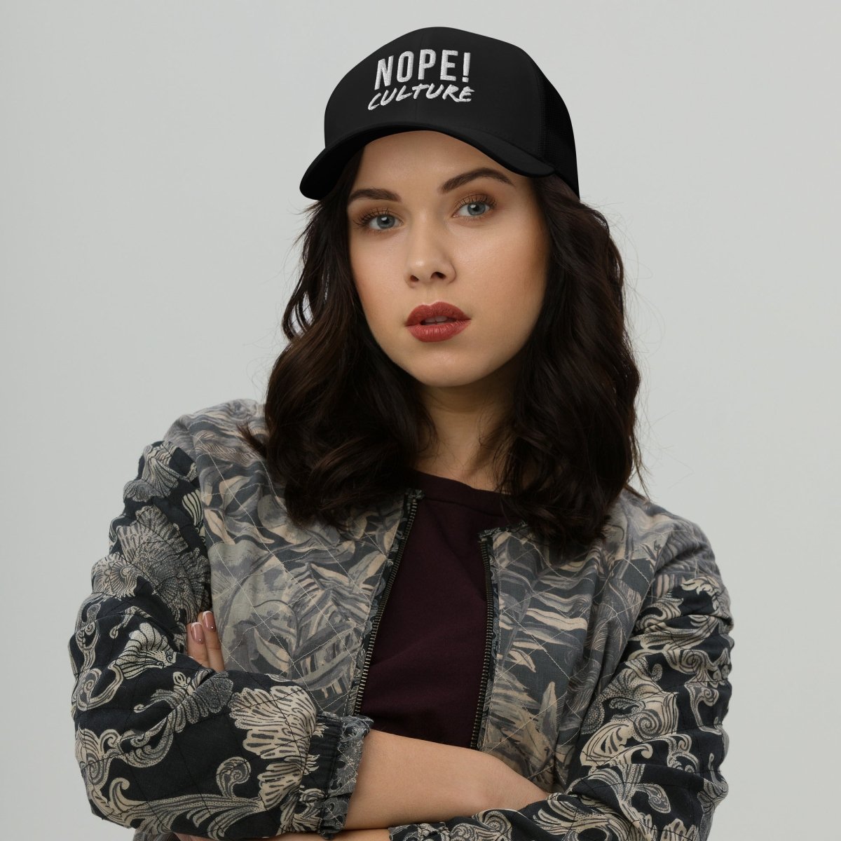 Woman wearing NOPE! Culture embroided black trucker cap