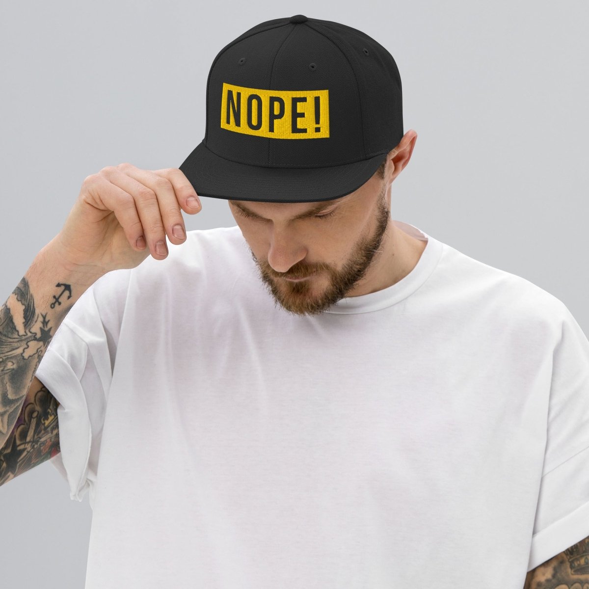 Man wearing High profile cap with yellow embroided NOPE!