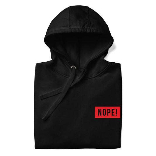 Close up of Black cotton hoodie with red NOPE! logo by NOPE! Culture with hood and logo in focus.