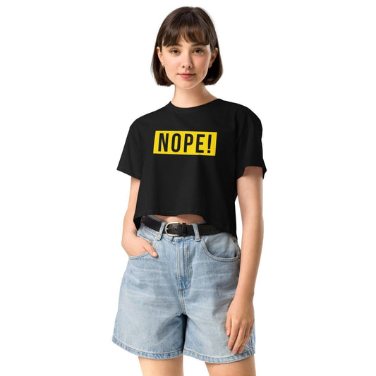 Woman wearing ladies black cotton crop top with bold NOPE! logo